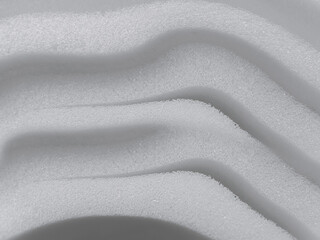 white foam sponge material texture background with wavy striped surface. thin industrial sponge material stack

