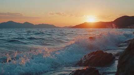 Serene sunset seascape with crashing waves against a rocky shoreline view