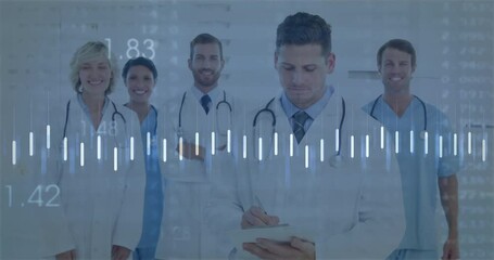 Medical team writing on tablet initiating data bars and line graph fluctuating monitoring vitals - Powered by Adobe