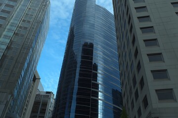 Fototapeta premium Skyscrapers reaching toward a bright blue sky