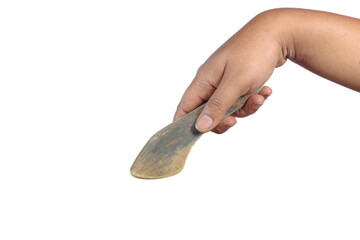Hand holding traditional wooden spatula with worn texture isolated on white