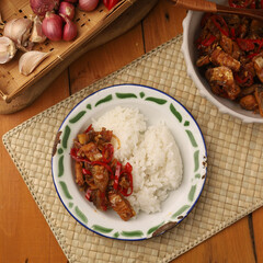 Stir fried salted fish with onion, garlic and chili on the table