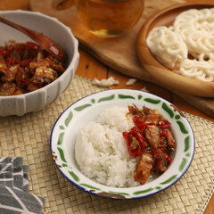 Stir fried salted fish with onion, garlic and chili on the table