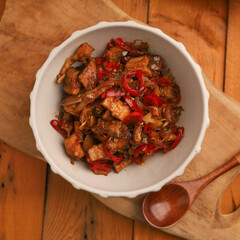 Stir fried salted fish with onion, garlic and chili on the table