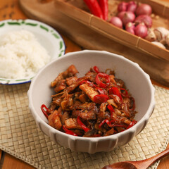 Stir fried salted fish with onion, garlic and chili on the table