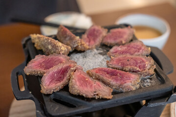 Set of Gyukatsu or beef cutlet on the grill. A traditional Japanese food that consists of a deep-fried beef cutlet.