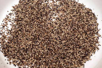 close up of pepper seeds on white background