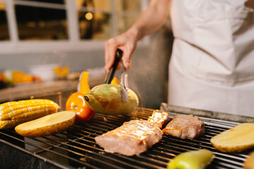 A cheerful summer barbecue gathering with friends and family grilling meat outdoors, enjoying food, laughter, and togetherness in a sunny garden.