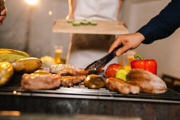 A cheerful summer barbecue gathering with friends and family grilling meat outdoors, enjoying food, laughter, and togetherness in a sunny garden.