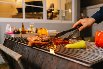 A cheerful summer barbecue gathering with friends and family grilling meat outdoors, enjoying food, laughter, and togetherness in a sunny garden.