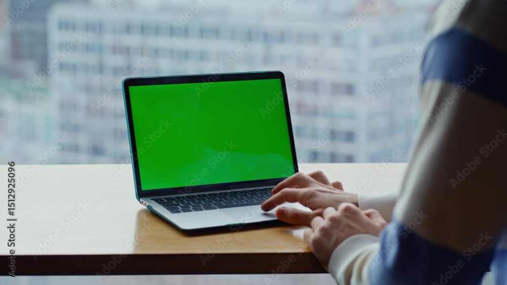 Poster man hands tapping chromakey computer touchpad at cityscape workplace closeup