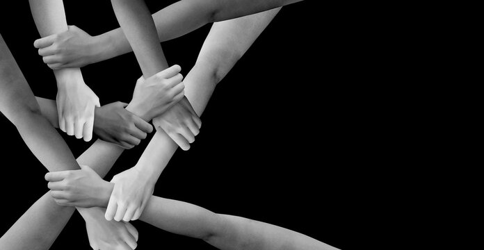 Business unity and teamwork as a group of diverse people holding arms as a multiracial society and corporate multicultural community joined and united team building concept.