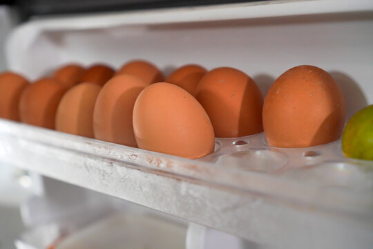 Brown Eggs In A Refrigerator Carton With Lime