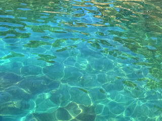 Serene turquoise sea, tranquil clear water surface.