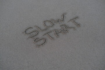 Slow Start – Handwritten Message on Volcanic Sand