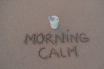 Morning Calm – Handwritten Message on Volcanic Sand with Thermos Mug