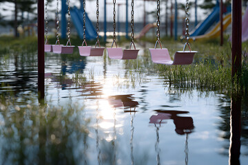 Sunlit Flooded Playground Ruin with Submerged Swings and Bright Plastic Slides