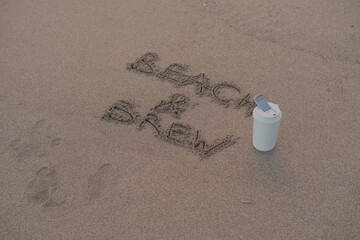 Beach and Brew – Handwritten Message on Volcanic Sand with Thermos Mug