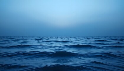 Blue aesthetic wallpaper of a calm ocean with gentle waves under a soft blue sky.