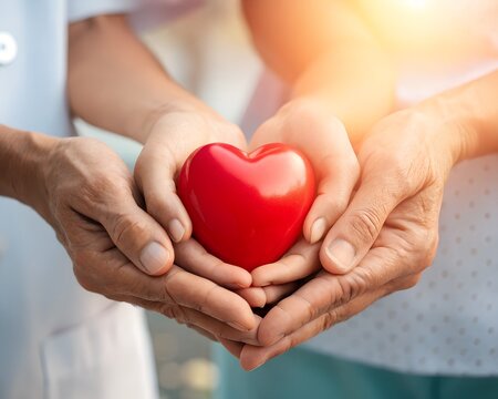 Hands Holding Red Heart Symbolizing Care