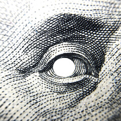 Close up eye hole of Benjamin Franklin on 100 dollar bill