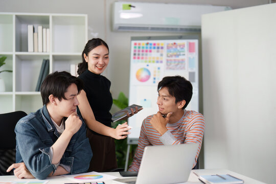 Collaboration and Creativity. Three graphic designers discussing design concepts and brainstorming ideas in a modern workspace. - Powered by Adobe