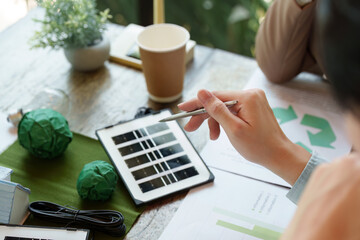 Sustainable Practices and Renewable Innovation. A professional analyzes renewable energy options in a collaborative setting.