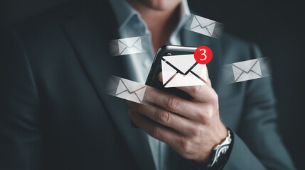 Businessman using smartphone checks message and email notifications.