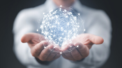 Hand holding digital glowing network globe, symbolizing global connection.