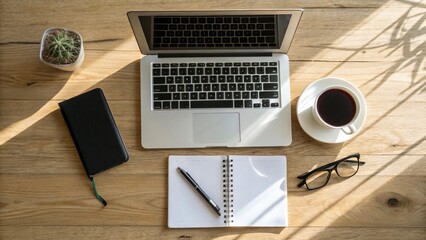 Office wooden desk table with other supplies with laptop computer and cup of coffee.