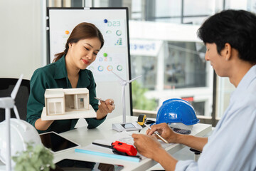 Fototapeta premium Collaborative ESG Discussion. Two professionals exploring sustainable architecture and renewable energy solutions.