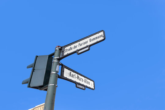 street sign Karl-Marx strasse and Strasse der pariser Kommune - engl - street of the paris commune and Karl Marz Alley in former east Berlin