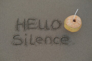 Hello Silence – Handwritten Message on Volcanic Sand with Coconut Drink