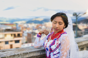 Indigenous bride wearing traditional andean dress posing in riobamba, ecuador