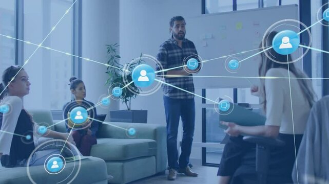 Presenter gesturing at whiteboard and activating network icons illustrating business connectivity - Powered by Adobe