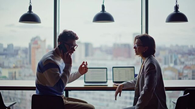 Disappointed business team failure city view office. Frustrated man talk phone