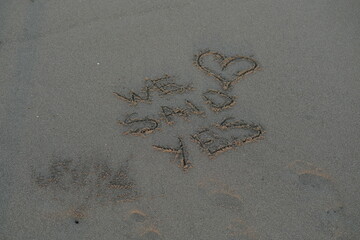 We Said Yes Message on Volcanic Sand with Heart Symbol