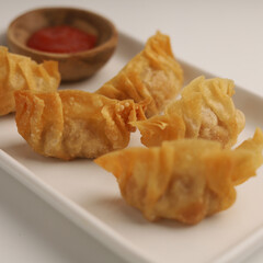 Gyoza or fried dumplings on a plate on white background