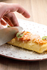 Chef slicing a delicate omelette for serving