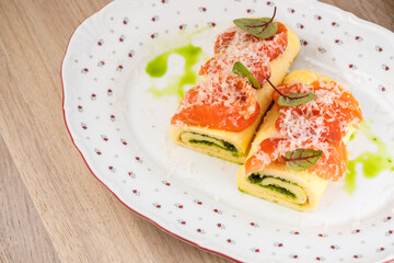 Savory pasta rolls topped with salmon and herbs