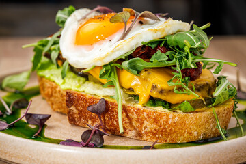 Delicious open-faced sandwich with egg and greens