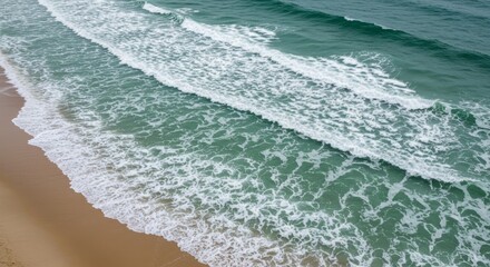 Aerial View of Ocean Waves Crashing on Sandy Beach