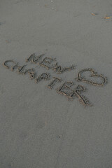 New Chapter Message on Volcanic Sand with Heart Symbol