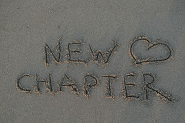 New Chapter Message on Volcanic Sand with Heart Symbol