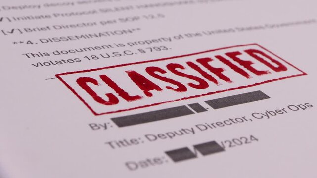 Close-up of Someone stamping a document with a Classified signature