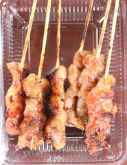 Delicious grilled pork placed on a food box