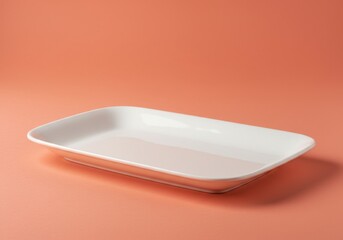 Empty white rectangular serving dish on peach background