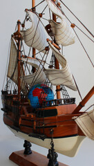 Model of the globe with sea routes between the continents drawn on the main deck of a scale model...