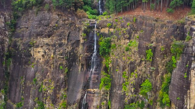 Top view of Beautiful waterfall in green forest. Tropical Bambarakanda Falls in mountain jungle, Sri Lanka.