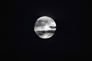 Mysterious full moon in dark clouds